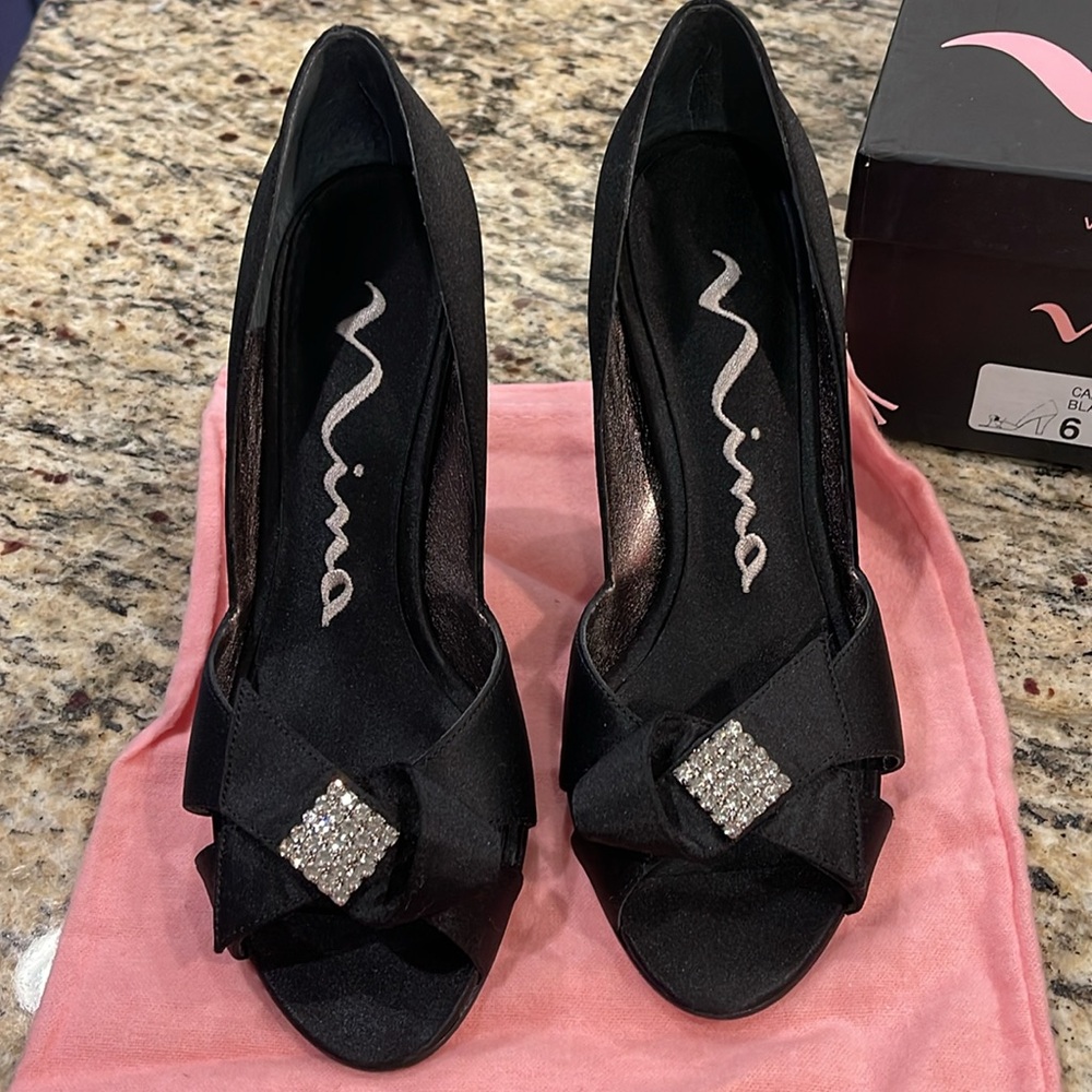 Nina brand, size 6, black open toe dressy 3” heels, bow with rhinestone on top.